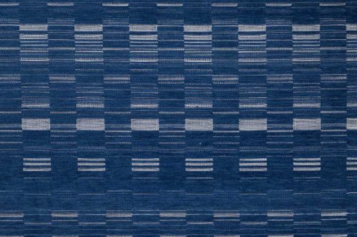 An outdoor, performance woven geometric stripe design in indigo tonal colours with white accents