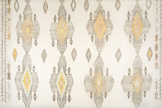 Geometric shapes in natural tones with pops of yellow and pale blue.