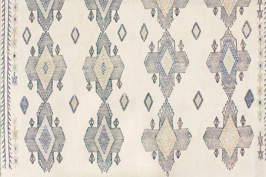 Geometric shapes in dark indigo tones with pops of blues and pale greens.