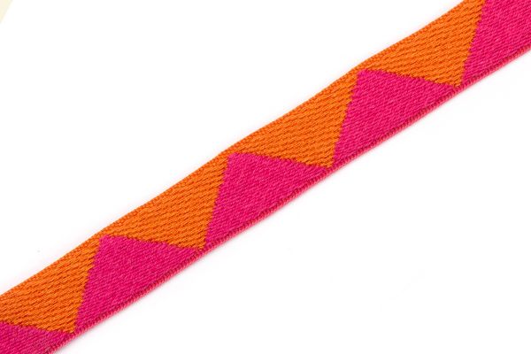 Big Top Tape fabric trim Hot Pink featuring a whimsical geometric pattern of pink and orange triangles, which can be added to curtains, drapery, upholstery or accessories.  