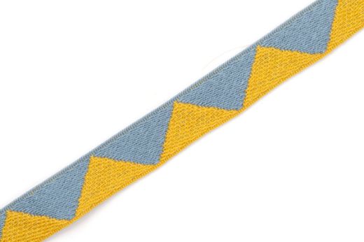 Big Top Tape fabric trim Old Blue featuring a whimsical geometric pattern of yellow and blue triangles, which can be added to curtains, drapery, upholstery or accessories.  