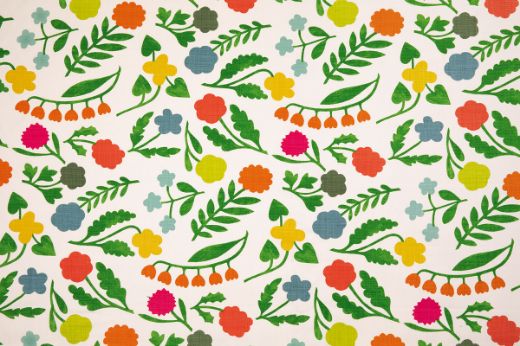 Array Linen Floral Fabric in green colourway, featuring a multi-coloured floral design with a dominant green tone, creating a fresh and vibrant nature-inspired pattern.