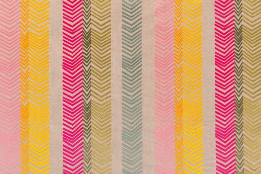 Bookend Embroidered Fabric by Kit Kemp on a natural linen base, featuring vibrant multi-coloured arrow embroidery in hot pink, yellow, orange, and light blue, creating a lively, textured design.