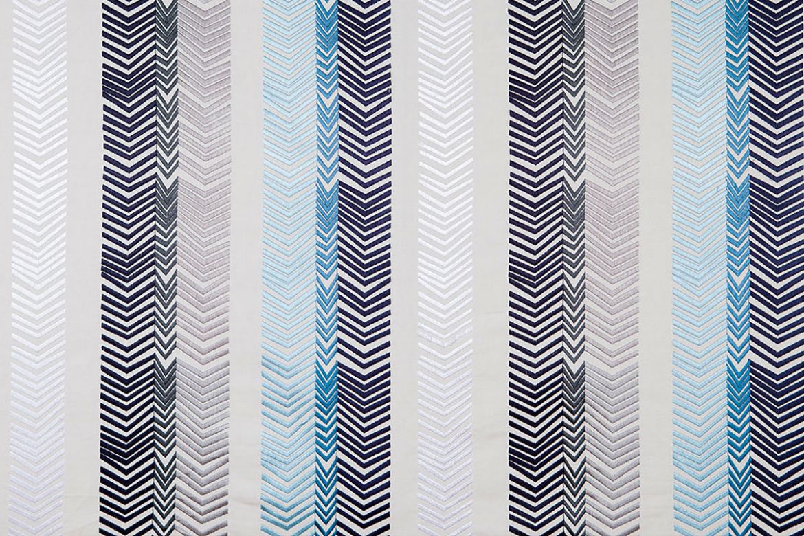 Bookend Embroidered Fabric by Kit Kemp featuring indigo blue and grey arrow embroidery in bold striped patterns, adding texture and colour to any interior.