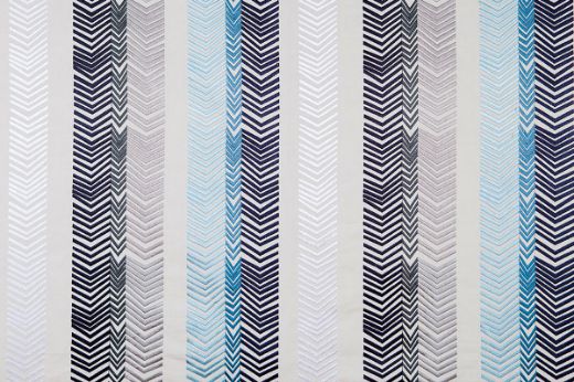 Bookend Embroidered Fabric by Kit Kemp featuring indigo blue and grey arrow embroidery in bold striped patterns, adding texture and colour to any interior.