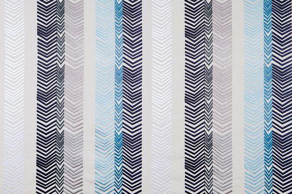 Bookend Embroidered Fabric by Kit Kemp featuring indigo blue and grey arrow embroidery in bold striped patterns, adding texture and colour to any interior.
