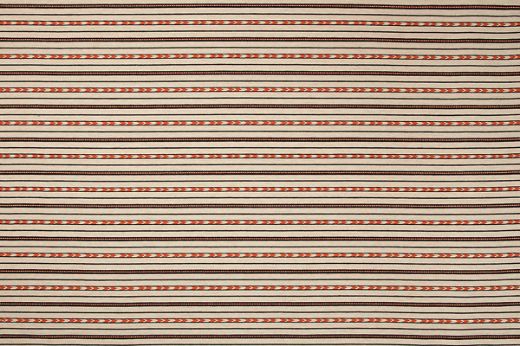Bow and Arrow Woven Fabric by Kit Kemp in natural colourway with navy blue stripes and red-orange arrow design, ideal for upholstery, curtains, and cushions, adding vibrant texture and style.