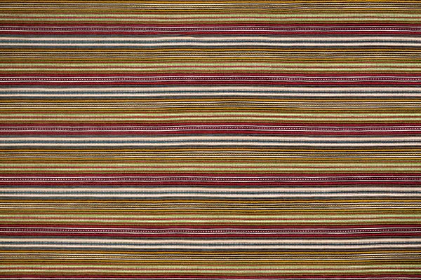 A multicoloured woven stripe design with dominant lime green tones, featuring rich textural variation and vibrant accents within a fresh, earthy palette.