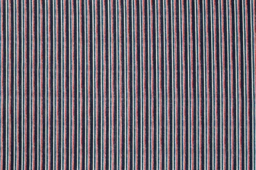 Close-up of Peace and Love fabric in deep blue and berry red stripes, printed on linen with bold, artistic flair.