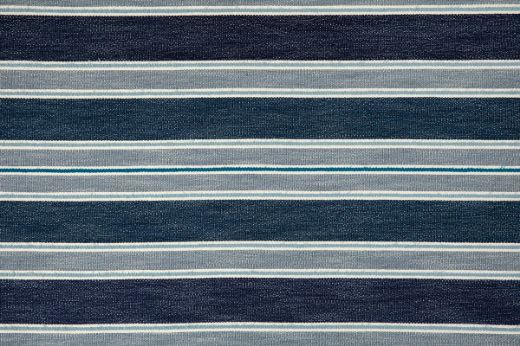 A striped woven fabric in blue tones with small stripes of lighter blues and teal.
