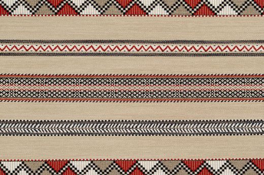 Woven fabric in red, navy and natural tones. Has zig zag motif stripes running horizonal.
