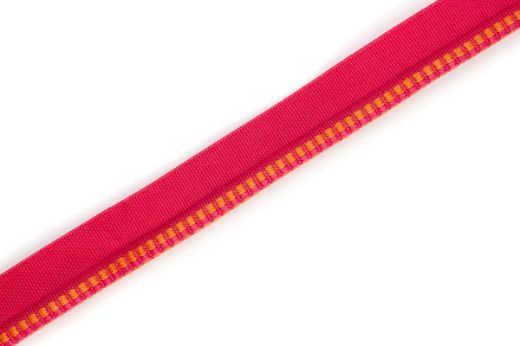  Hopscotch Performance Piping in Rosa, with a soft pink woven square pattern, offering a stylish yet resilient trim for upholstery in high-traffic and outdoor environments.