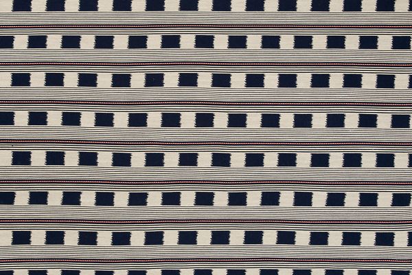 Lost and Found fabric in rich indigo, featuring a woven check pattern with contrasting orange stripes. This deep, sophisticated hue adds a sense of luxury and refinement, ideal for upholstery, feature headboards, and custom soft furnishings.