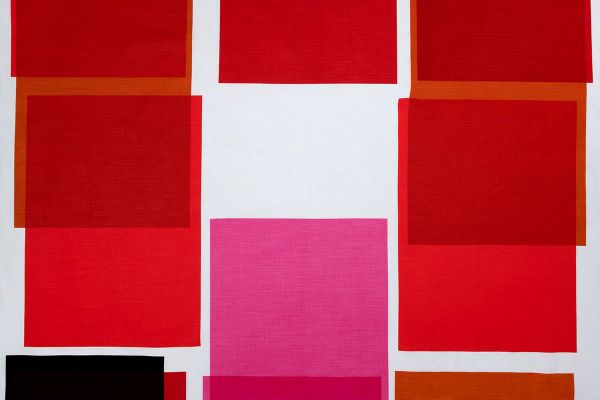 Large scale printed overlapping blocks in shades of reds and bright pink 