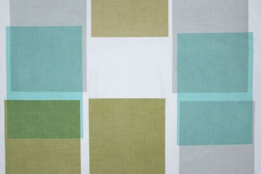 Large scale printed overlapping blocks in shades of sage green, bright light blue and light grey