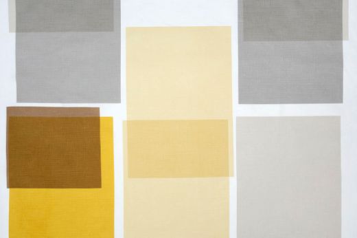 Large scale printed overlapping blocks in shades of greys and yellows