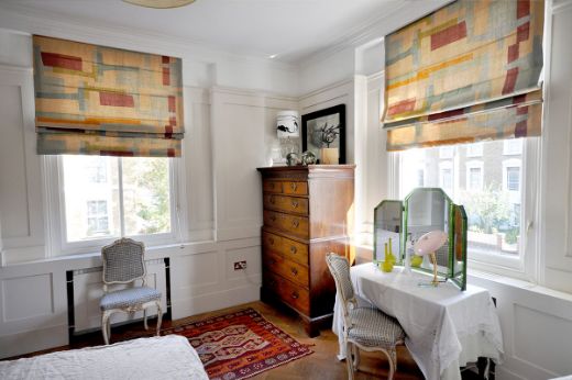 Room design by Virginia White, Photography by Colin Hampden-White. Span fabric on two roman blinds.