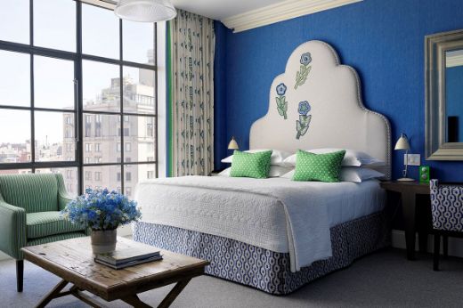 Hotel room in Firmdale Hotels with blue and green colours. Large headboard with Tasha's Trip green