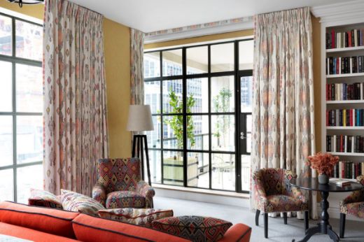 Photograph of Ham Yard Hotel by Oliver White-Smith. Shows a room with travelling light orange curtains.