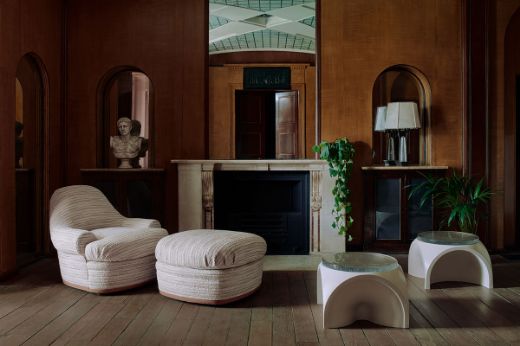Design by And Objects, Photography by Michael Sinclair. Image of a room with an armchair and ottoman in Wanderer Ecru fabric in front of a fireplace 