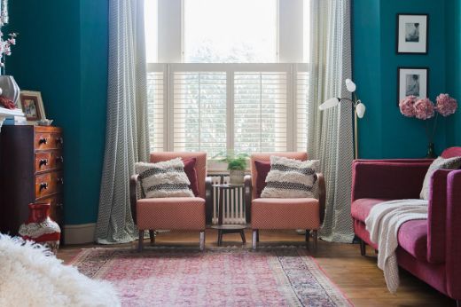 Design by Brooke Copp Barton. Image shows a living room with large window which has zenith sage curtain to either side. 