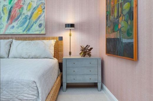 Custom colour Bark Raffia textured wallpaper in bedroom with rattan bed and abstract fine artwork on walls, creating a stylish and contemporary interior.