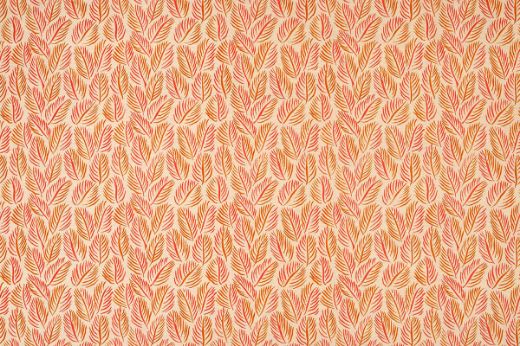 Armatures Feuilles luxury printed linen fabric in a small leaf print used for upholstering a stylish armchair, featuring soft orange and natural tones