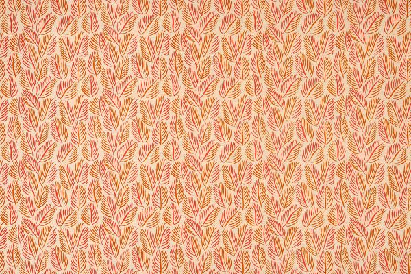 Armatures Feuilles luxury printed linen fabric in a small leaf print used for upholstering a stylish armchair, featuring soft orange and natural tones