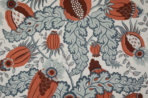 Christopher Farr Cloth Carnival Indoor Printed Wallpaper Rust. A detailed botanical illustration featuring large stylised flowers in shades of terracotta orange and blue, with intricate leaves and stems on a light background.