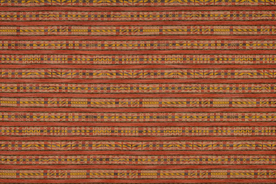 Hotline fabric in rich reds and yellow tones. Has a horizontal stripe of geometric designs