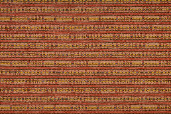Hotline fabric in rich reds and yellow tones. Has a horizontal stripe of geometric designs