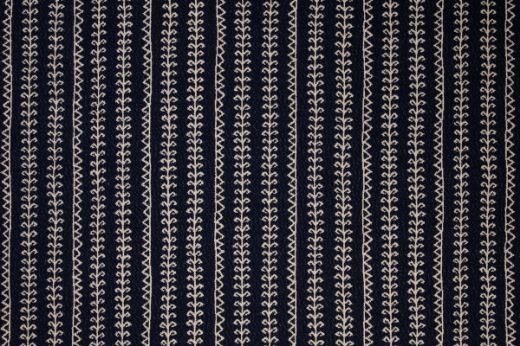Woven fabric in indigo with geometric patterned stripes going vertical 