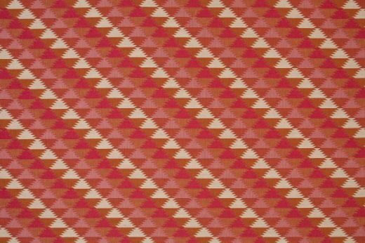 Woven fabric in pinks and reds colours in a geometric pattern  