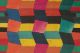 Bright colourful geometric blocks fit together to create a zig zag pattern in pinks, yellow, greens and blues.