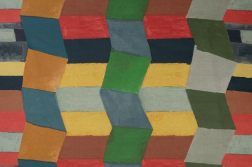 Bright colourful geometric blocks fit together to create a zig zag pattern in blues, greens and yellows