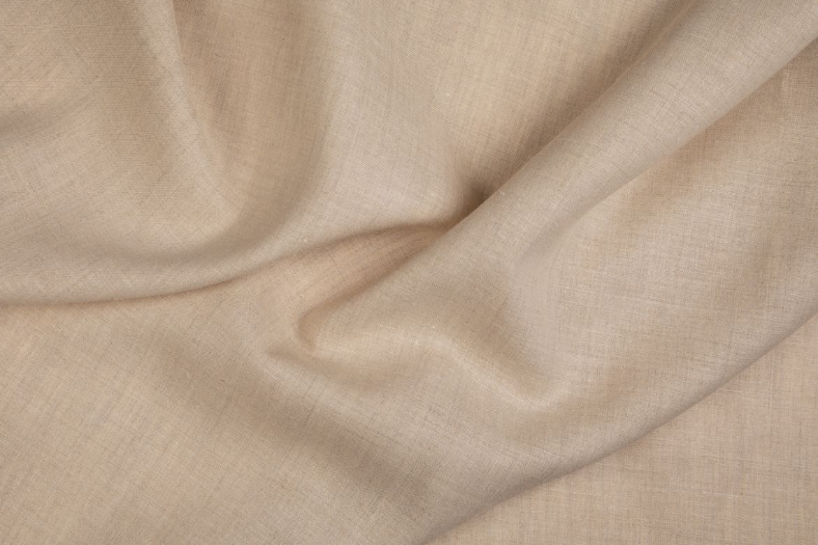 Malmedy fabric in soft beige, draped to show texture.