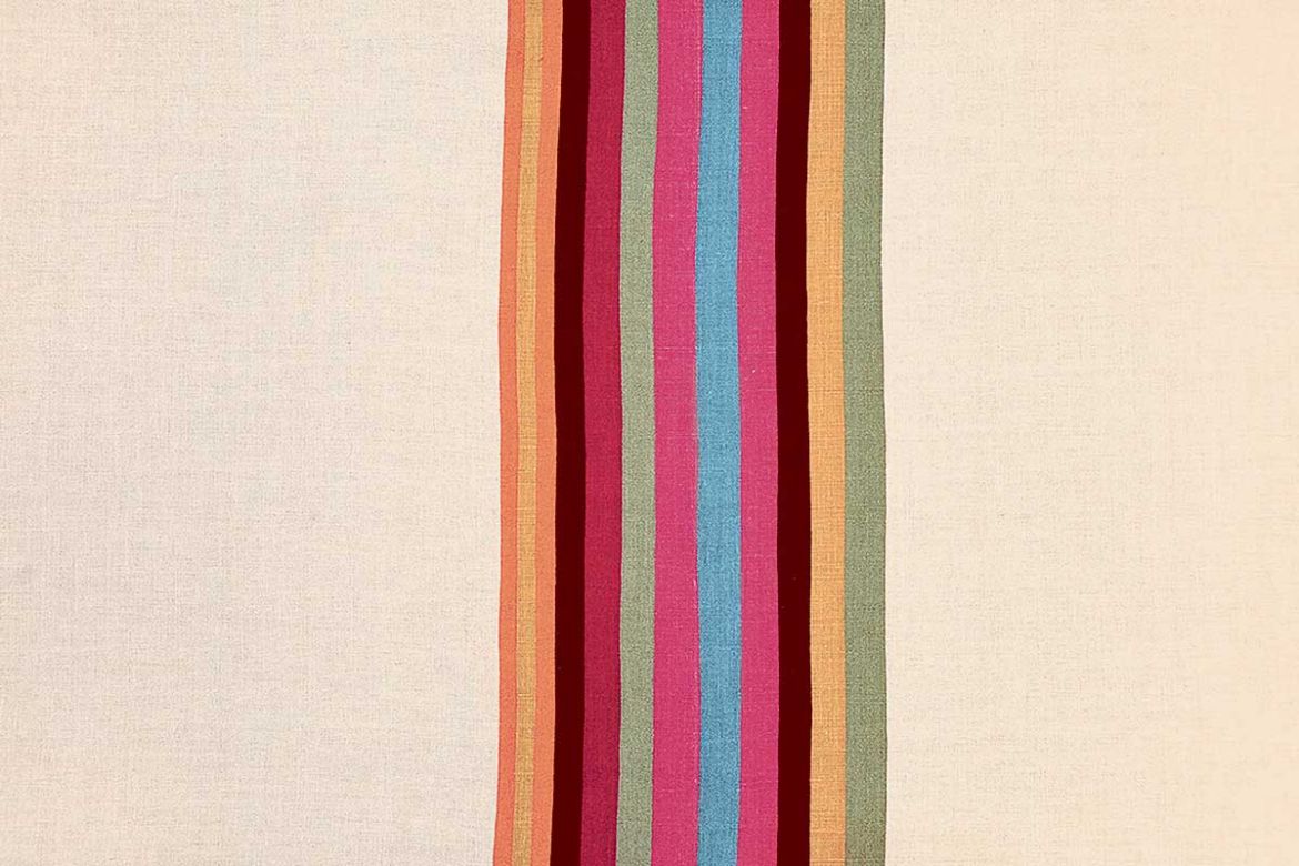 Striped printed fabric in oranges, pinks, blues and green.