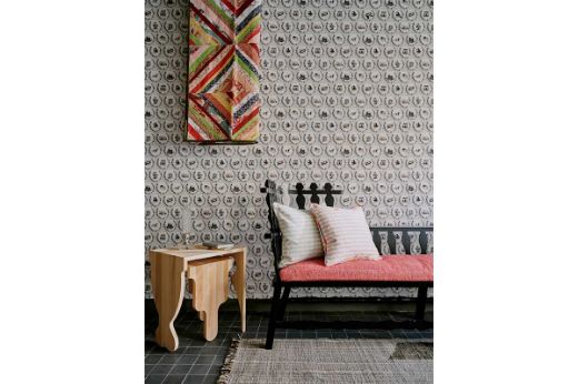 Interior with bench and artwork, featuring “Set the Scene” wallpaper in neutral tones on the wall. Set the Scene Custom Wallpaper, Photography by Christopher Horwood 