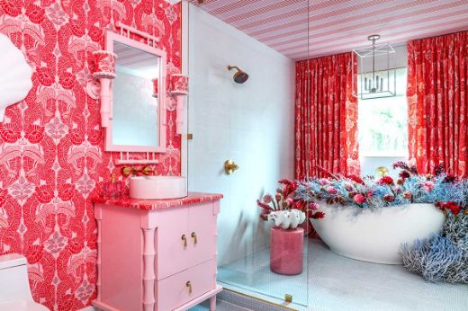 Maximalist bathroom featuring the Christopher Farr Cloth Belle De Nuit & Hudson Stripe wallpapered walls and ceiling, with vibrant fuchsia pink accents. The room showcases bold floral and striped patterns on the ceiling, creating a luxurious, high-contrast look. The space is designed by Megan Gorelick Interiors, blending striking colours and textures to create a dramatic, stylish atmosphere 