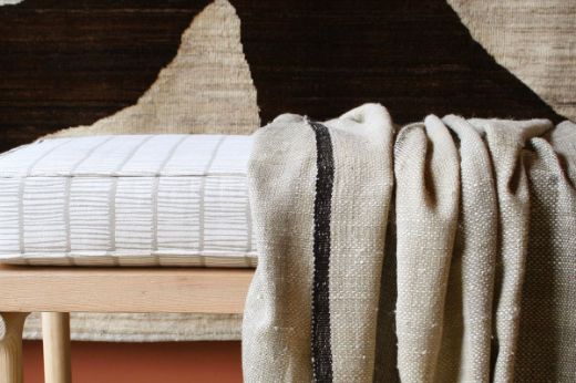 Textured woven striped natural throw black edging christopher farr cloth