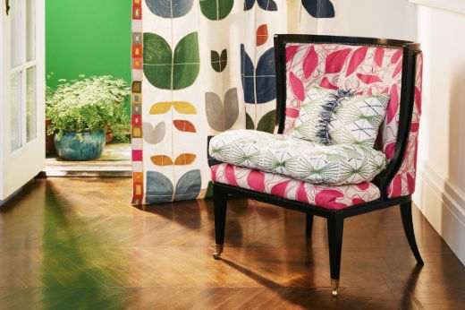 Christopher Farr Cloth Foliage Hot Pink upholstered chair with Mikado Green cushion and Happy Flowers dark indigo curtain with Totum Hot Pink embroidered trim border 