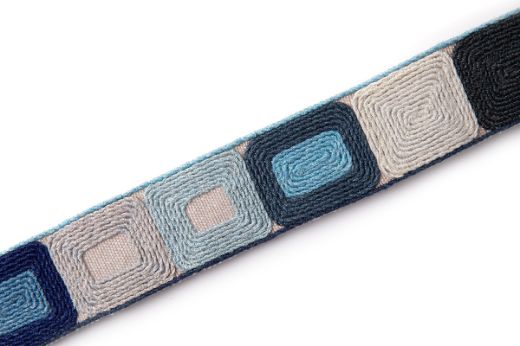 Totum Indigo is a embroidered geometric trim in indigo and pale blues