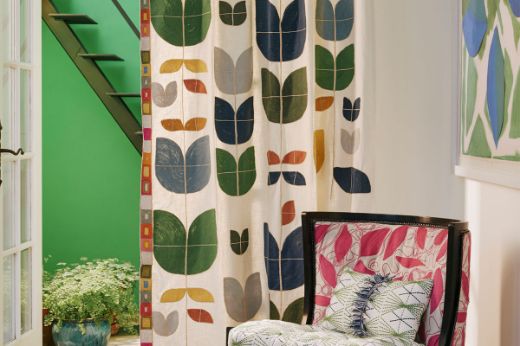 embroidered geometric hot pink Totum trim edge with a curtain in Happy Flower Indigo and Foliage hot pink upholstered chare and Mikado Green Cushion 
