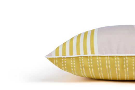 Side view of The Hudson Stripe Outdoor Cushion featuring a bold and intricate stripe design in Limone yellow, soft pink and white, offering a modern yet timeless look for outdoor spaces.