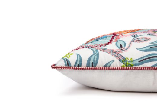 Limited Edition 03 Aubergine Carnival Cushion featuring a vibrant purple and blue tone with a hand-stitched pomegranate floral and leaf design, side view
