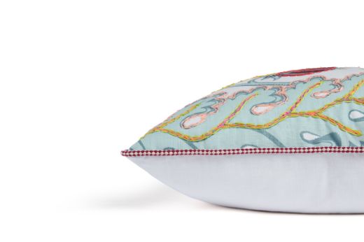 Limited Edition 05 Aubergine Carnival Cushion featuring a vibrant purple and blue tone with a hand-stitched pomegranate floral and leaf design, side view