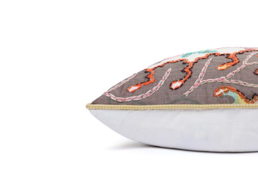 Side View of Limited Edition 02 Stockholm Carnival Cushion featuring warm brown, yellow, and mint hues with a hand-stitched pomegranate floral and leaf design, adding an artistic touch to your décor.
