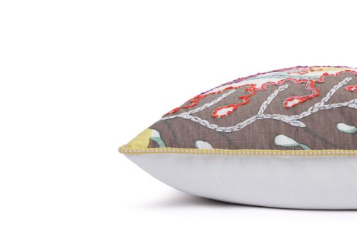 Side View of Limited Edition 03 Stockholm Carnival Cushion featuring warm brown, yellow, and mint hues with a hand-stitched pomegranate floral and leaf design, adding an artistic touch to your décor.