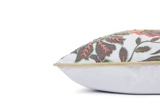 Side View of Limited Edition 04 Stockholm Carnival Cushion featuring warm brown, yellow, and mint hues with a hand-stitched pomegranate floral and leaf design, adding an artistic touch to your décor.