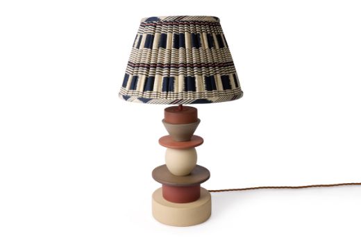 Totum ceramic lamp base featuring multi-coloured glazed blue, pink, and yellow with natural clay stacked components in triangle and circle shapes. Gold E27 bulb holder and twisted gold wire enhance the elegant design. Paired with the Lost and Found Indigo checkered pleated lampshade, this lamp creates a fun, geometric statement piece for your interiors.